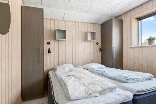 a bedroom with two beds in it with a window at 2002-Romo-Juvrevej-51b in Høm