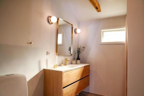 a bathroom with a sink and a mirror at 13345-1-Vig-Poppelvej-21 in Vig