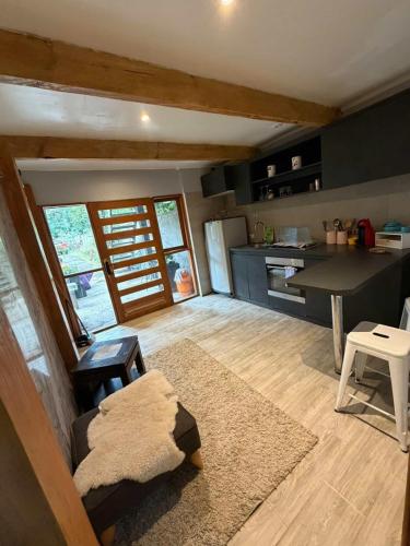 a kitchen and living room with a couch and a table at departamento de interior Pucón in Pucón