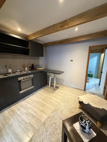 a kitchen with a table and a couch in a room at departamento de interior Pucón in Pucón