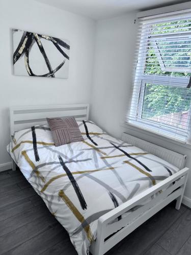 a white bed in a room with a window at Watford Junction Stay in Watford