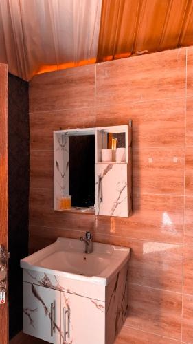 a bathroom with a sink and a mirror at Pearl of the desert camp in Wadi Rum