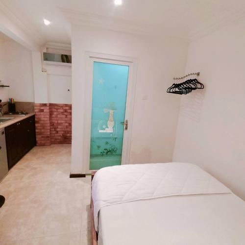 a bedroom with a bed and a door to a bathroom at Nortram Homes - Adenta in Apenkwa