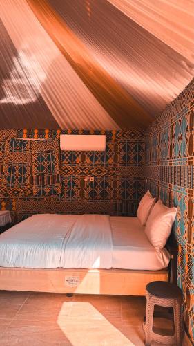 a bedroom with a bed in a room at Pearl of the desert camp in Wadi Rum
