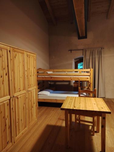 a room with two bunk beds and a table at Rifugio Forte di Machaby in Arnad