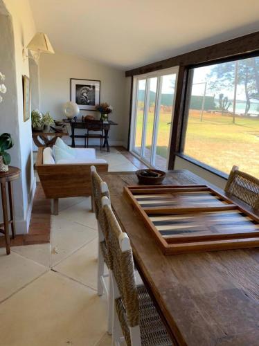 ein Esszimmer mit einem Tisch und ein Wohnzimmer in der Unterkunft Casa do Ventoo in Búzios