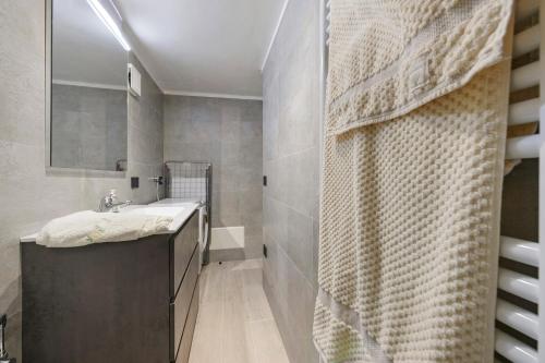 a bathroom with a sink and a mirror at Lueur de la Rouja in Champoluc