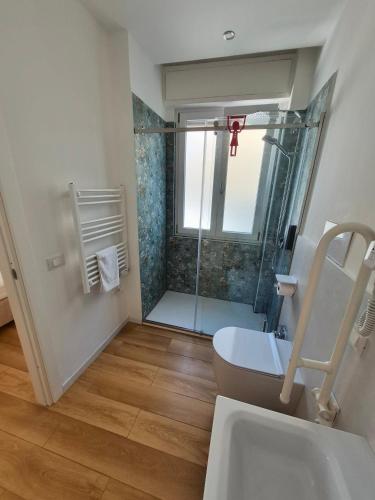 a bathroom with a shower and a toilet and a sink at B&B Magnolie in Palermo