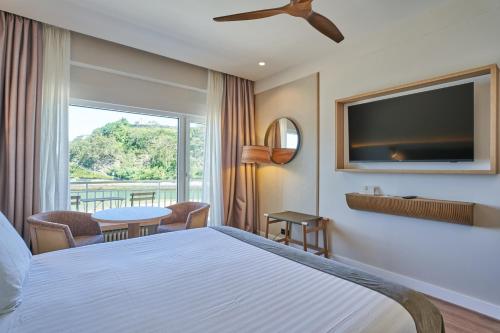 a hotel room with a bed and a television at Silken Gran Hotel del Sella in Ribadesella