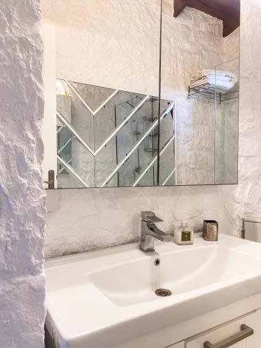 a bathroom with a sink and a mirror at Casa del Olivia in Seferihisar