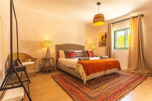 a bedroom with a bed and a tripod in a room at Villa Arta by Hostiva in Comporta