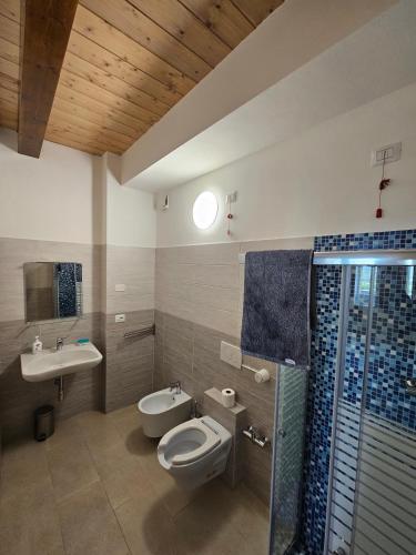 a bathroom with a toilet and a sink at Country House Andromeda in Offida