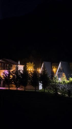 a group of houses at night with lights at Arditi's Villa in Shkodër