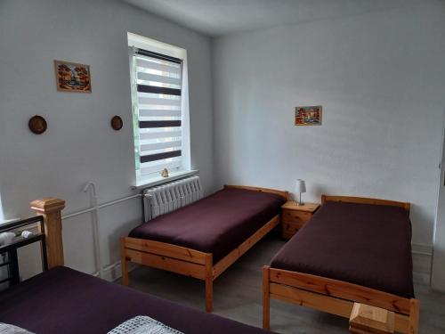 a room with two beds and a window at FeWo s Runde Wiese WR in Greifswald