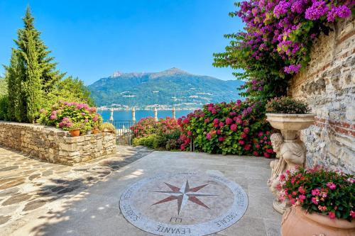 a garden with flowers and a star on a stone path at Villa Marina - Como lake in Bellano