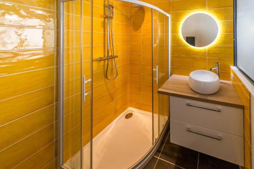 a bathroom with a shower and a sink and a tub at Le Balcon Gaillard in Brive-la-Gaillarde