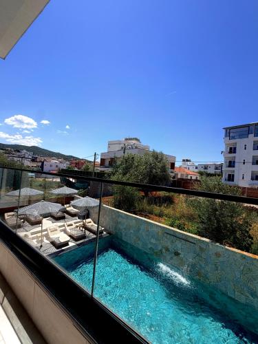 a view of a swimming pool on a balcony at Hotel Utopia in Ksamil
