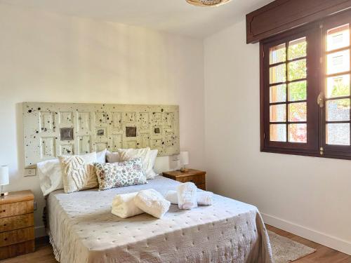 a bedroom with a bed with two pillows on it at Villa Hermida in Sanxenxo