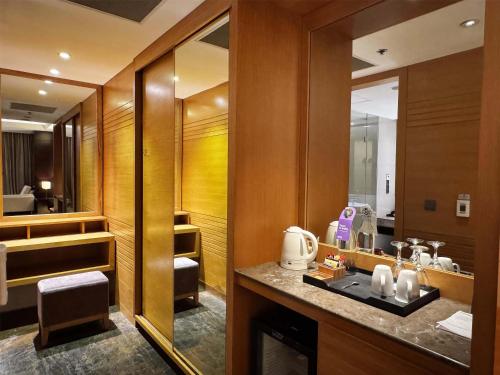 a bathroom with a sink and a mirror at Radisson Blu Chattogram Bay View in Chittagong
