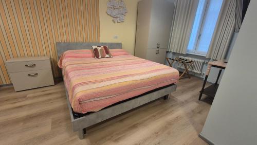 a bedroom with a bed with two pillows on it at MoMa Home Villasanta Monza Park in Villasanta