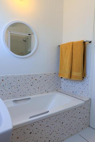 a bathroom with a sink and a mirror at Seaward Studio Suite in Ramsgate