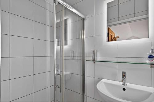 a white bathroom with a sink and a mirror at 1 Bed in Belford oc-cn002 in Lucker