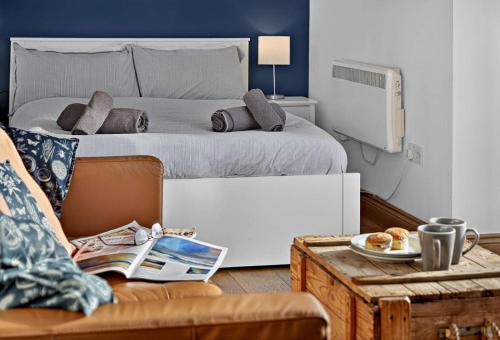 a bedroom with a bed and a couch and a table at 1 Bed in Belford oc-cn002 in Lucker