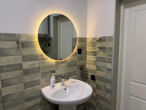 a bathroom with a sink and a mirror at Duplex Hause in Telavi