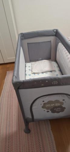a blue crib with a white pillow in it at Apartman Legac in Starigrad