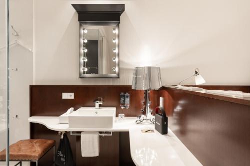 a bathroom with a sink and a mirror at Ruby Lilou Hotel Marseille by IHG in Marseille