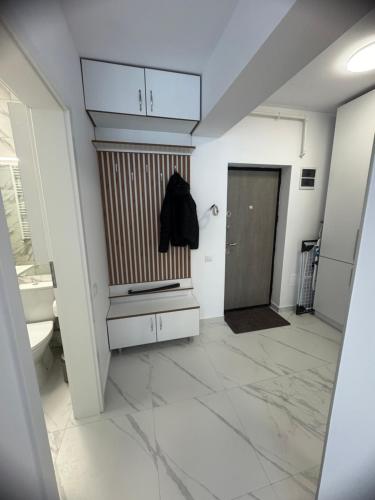 a bathroom with a sink and a toilet and a door at Studio Militari Residence - MR1 in Chiajna