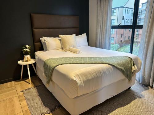 a bedroom with a large bed with a window at Midrand Stylish 1Bedroom Escape in Midrand