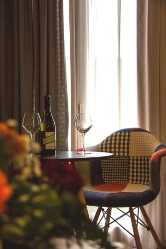 a table with two glasses and a bottle of wine at Kastalia Boutique Hotel in Delfoi