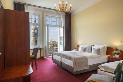 a hotel room with a bed and a large window at Garner Hotel Hamburg St. Georg by IHG in Hamburg