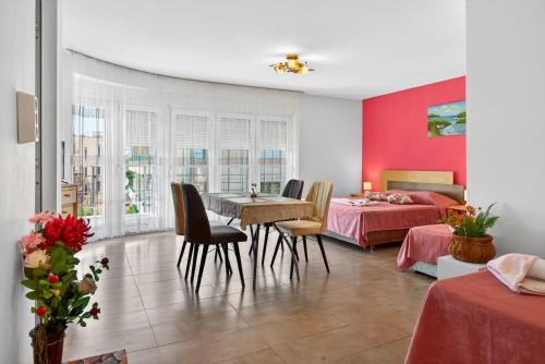 a bedroom with two beds and a table and chairs at Вила Далия - Несебър in Nesebar