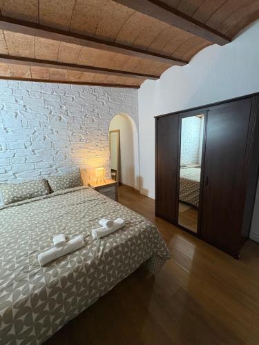 a bedroom with a bed and a brick wall at Villa CarlaSophia in Calasparra