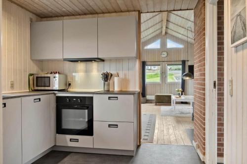 a kitchen with white cabinets and a stove at G308-Lemvig-Violvej-108 in Lemvig
