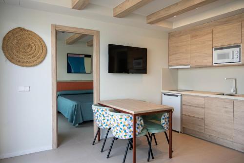 a small kitchen with a table and chairs in a room at The White Apartments in San Antonio