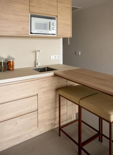 a kitchen with a wooden counter top and a microwave at The White Apartments in San Antonio