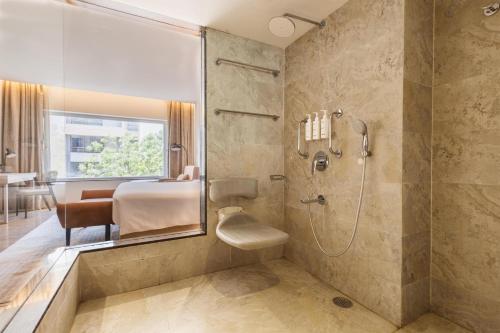 a bathroom with a shower and a sink at Temple Tree Hotel Shirdi, a member of Radisson Individuals in Shirdi