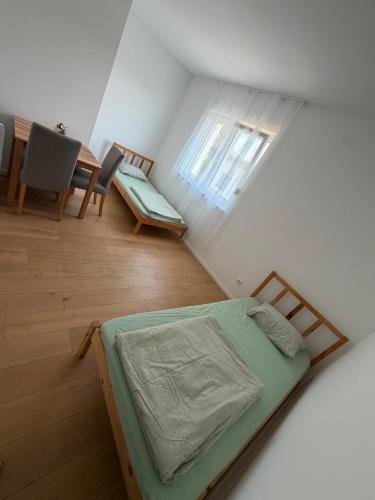 a room with a bed and a table and chairs at Ruhige Gästehaus AVOLli in Mellach