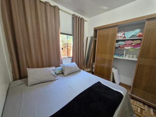 a bedroom with a large bed and a window at Casa da Nair in Sao Jorge
