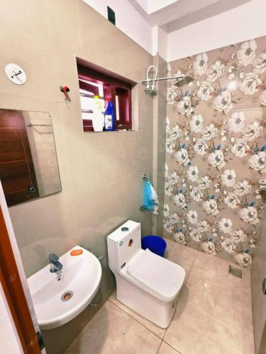 a bathroom with a toilet and a sink at Darshan Stay in Trichūr