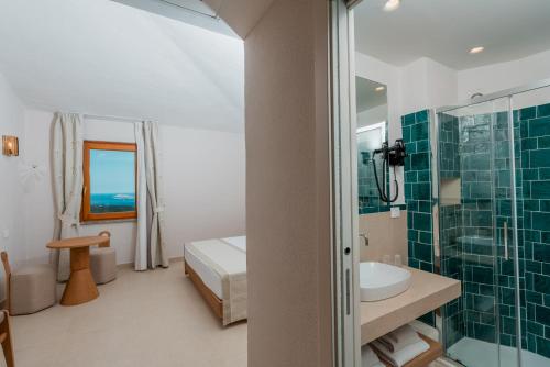 a bathroom with a sink and a shower at Hotel Rocce Sarde in San Pantaleo