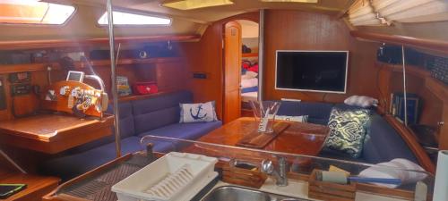 a living room with a sink and a tv on a boat at Echappée belle in Cros-de-Cagnes