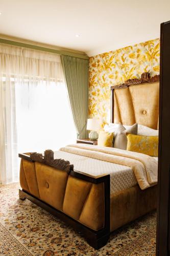 a bedroom with a large bed with a large window at Jul Rick House Guesthouse in Sandton