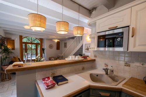 a kitchen with a sink and a counter top at L'ecrin de séraphie in Nojaret