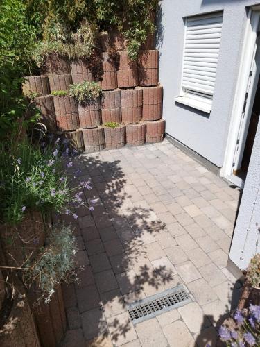 a patio with a bunch of bricks next to a house at Gästezimmer mit eigenem Eingang in Schwäbisch Hall
