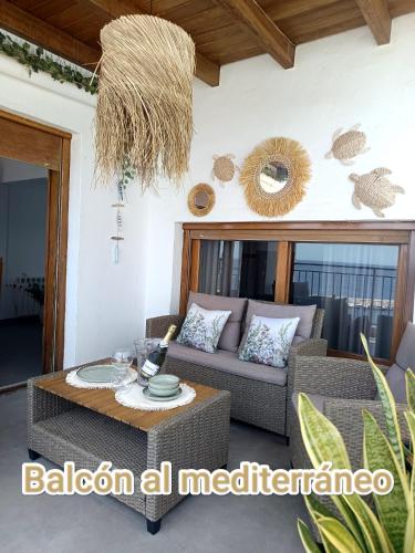 a living room with a couch and a table at Apartamento Balcón al Mediterráneo in Moraira
