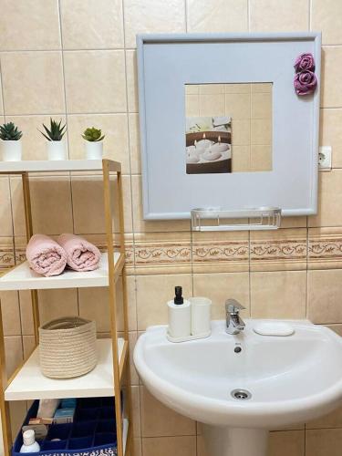 a bathroom with a sink and a mirror at Casa Candy. Piscina, Mar y Paz. in Tuineje